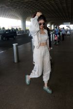 Sanjana Sanghi holding bag wearing cream colored long sleeved top and trousers and grey footwear with laces (19)_646f3eff55737.jpg