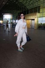 Sanjana Sanghi holding bag wearing cream colored long sleeved top and trousers and grey footwear with laces (3)_646f3ecd2adbc.jpg