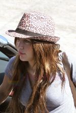 Miley Cyrus arrives at a studio in Burbank wearing a leopard print fedora, Loe Angeles, California on 25th August 2009 - IANS-WENN (1).jpg