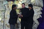 AR Rahman receives his award from Shahrukh Khan and Lowell Paddock President and Managing Director General Motors India.JPG