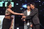 Dhanush receives the Best Playback Singer Male award for the movie 3 (Why this kolaveri di) from Catherine and Anirudh during the 60th Filmfare Awards.jpg