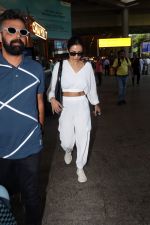Malaika Arora in white wearing dark glasses white sneakers and holding black Chanel Bag  (3)_64744735294d8.jpg