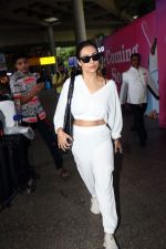 Malaika Arora in white wearing dark glasses white sneakers and holding black Chanel Bag  (6)_6474479611612.jpg