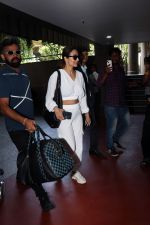 Malaika Arora in white wearing dark glasses white sneakers and holding black Chanel Bag  (9)_6474475d92366.jpg
