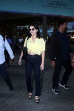 Sunny Leone is dressed in a yellow shirt blue jeans sunglasses and black high heels (13)_64742372a9529.jpg