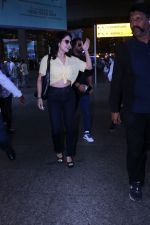 Sunny Leone is dressed in a yellow shirt blue jeans sunglasses and black high heels (22)_647423aece908.jpg