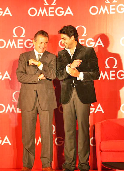 Abhishek Bachchan and Stephen Urquhart, President, Omega, pose with their Omega watches