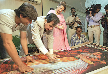 Dilip Kumar walks down the memory lane as he shows a Mughal-e-Azam poster to Saira Bano and Shahrukh.