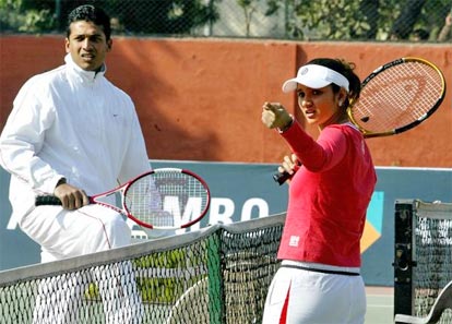Sania Mirza talks with Mahesh Bhupathi during a coaching clinic for children