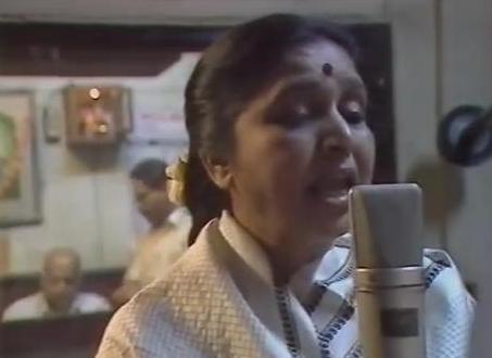 Asha recording a song in the studio