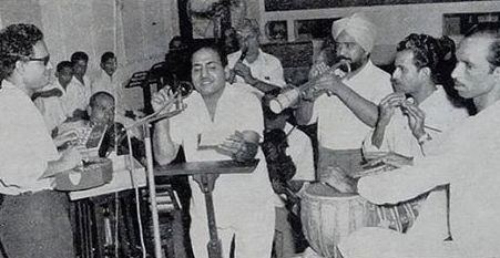 Mohd Rafi recording a song with musicians in the recording studio