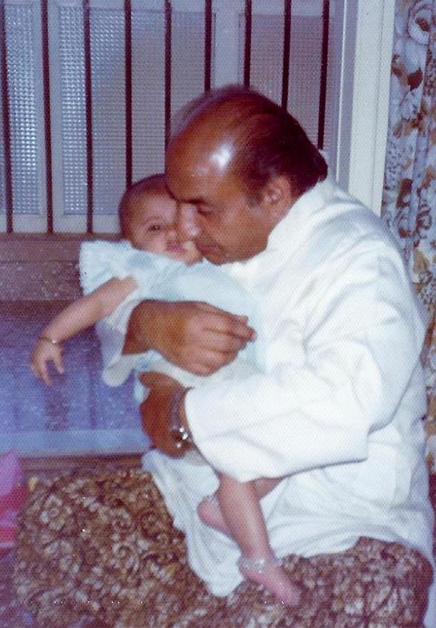 Mohammad Rafi holding his grandchild