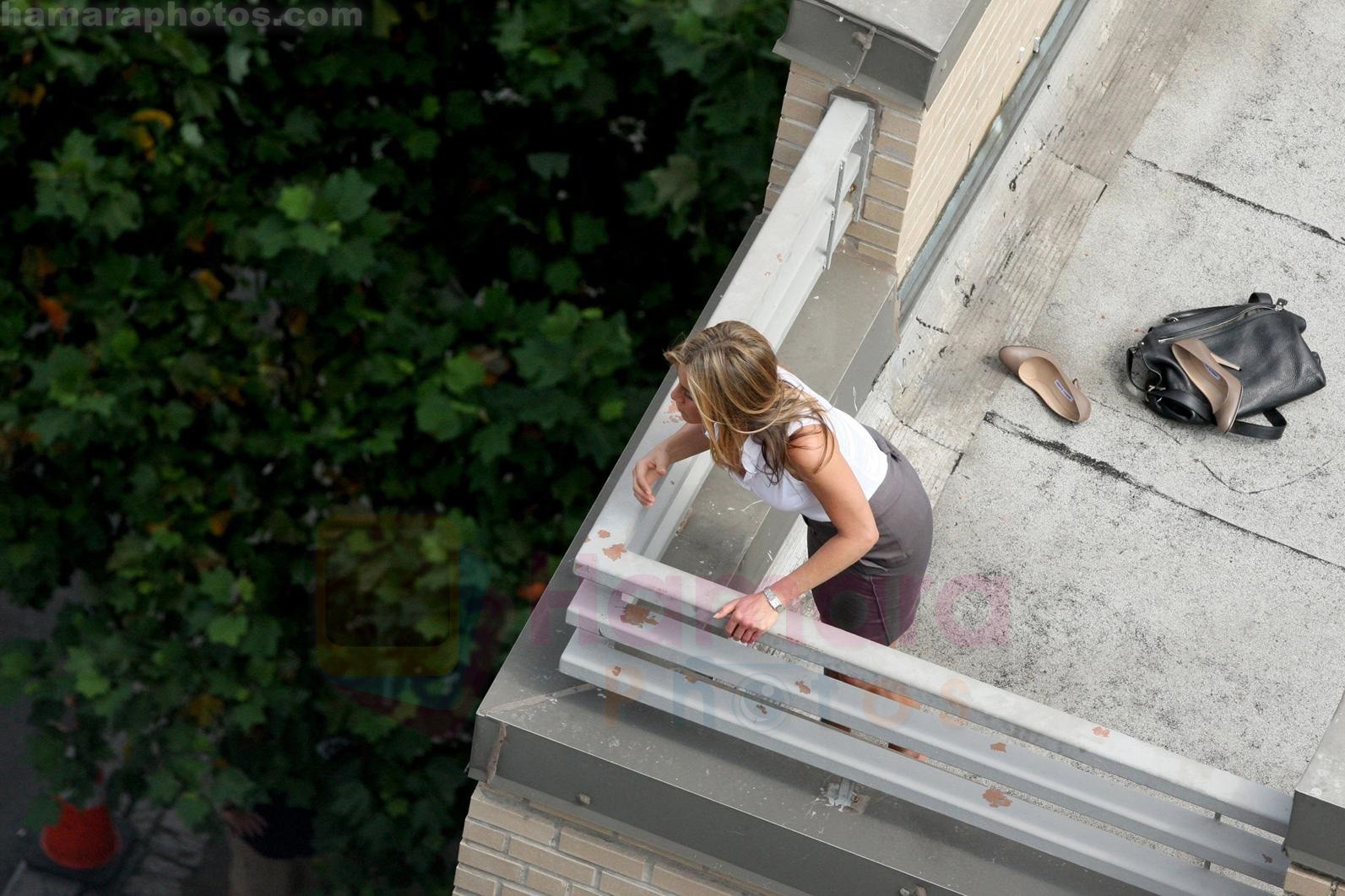 Jennifer Aniston keeps cool, by having a assistant hold up a huge fan in front of her, while on the set of her new film on 22.08.09 