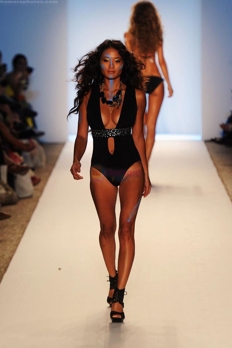 A model walks the runway at the A.Che show during Mercedes-Benz Fashion Week Swim 2012 at The Raleigh on July 16, 2011 in Miami Beach, Florida