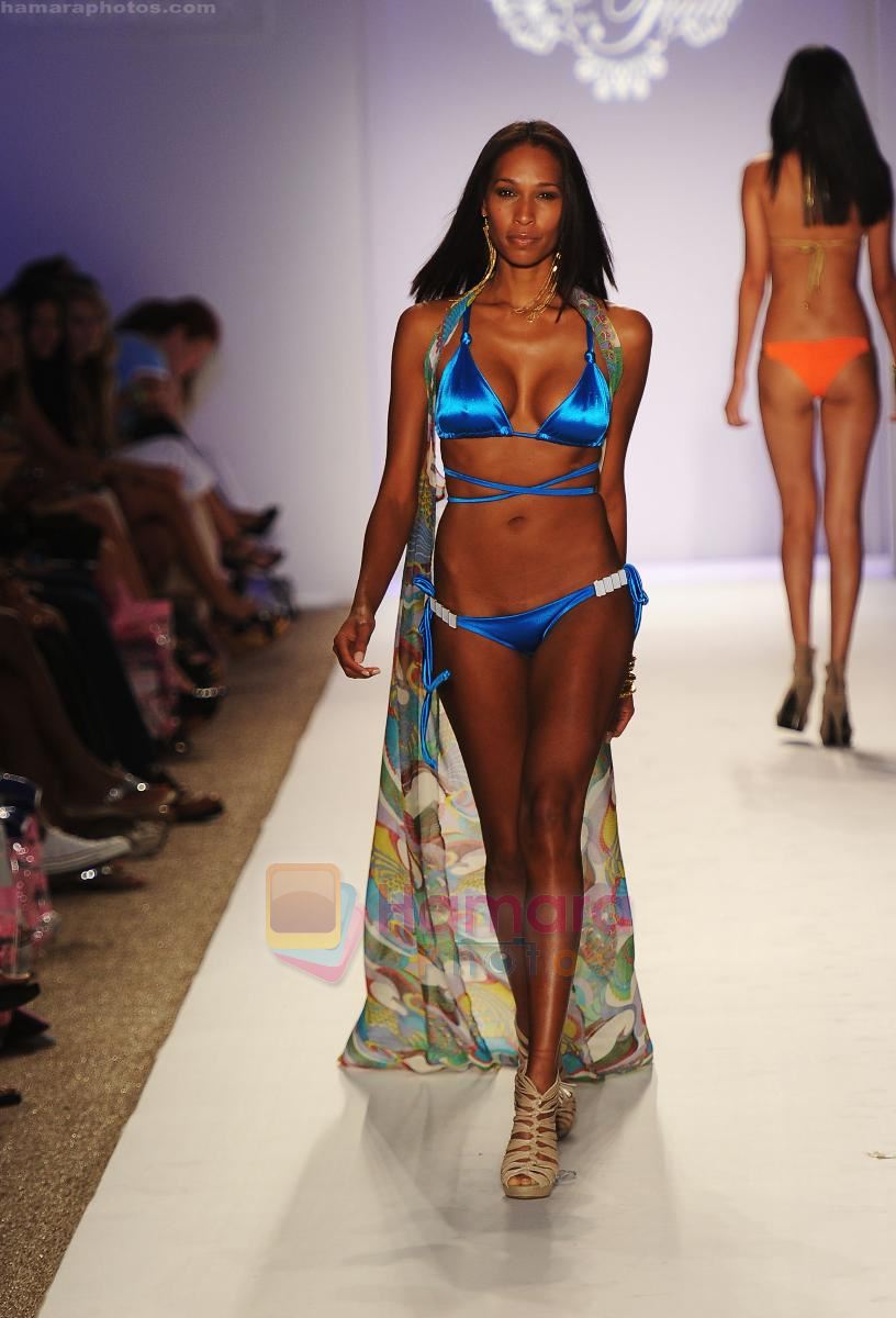 A model walks the runway during the Have Faith Swimwear show at The Raleigh on July 18, 2011 in Miami, Florida
