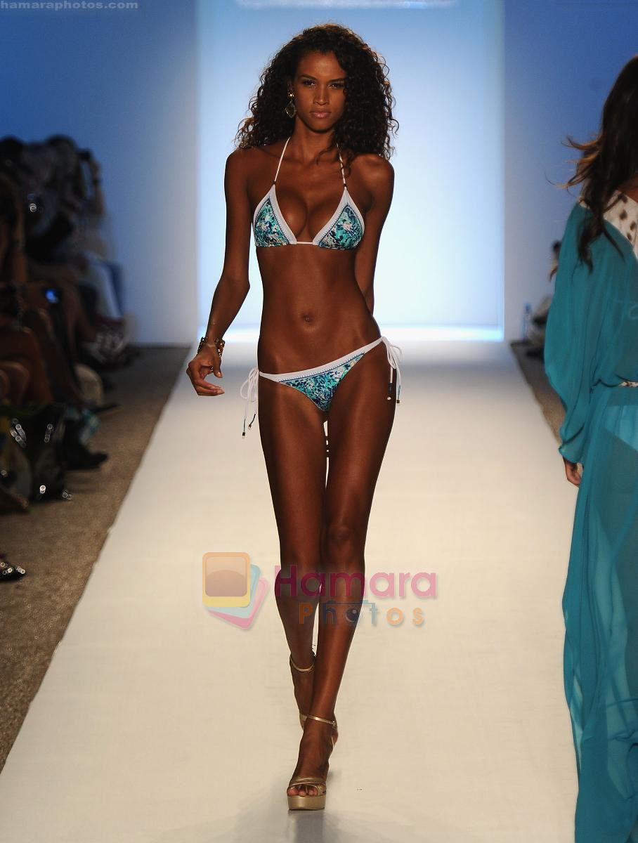 A model walks the runway for the Caffe Swimwear show during Mercedes-Benz Fashion Week Swim 2012 at The Raleigh on July 16, 2011 in Miami Beach, Florida