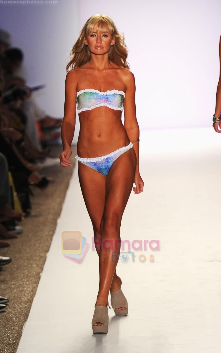 A model walks the runway at the Tavik Swimwear show during Merecedes-Benz Fashion Week Swim 2012 on July 18, 2011 in Miami Beach, United States