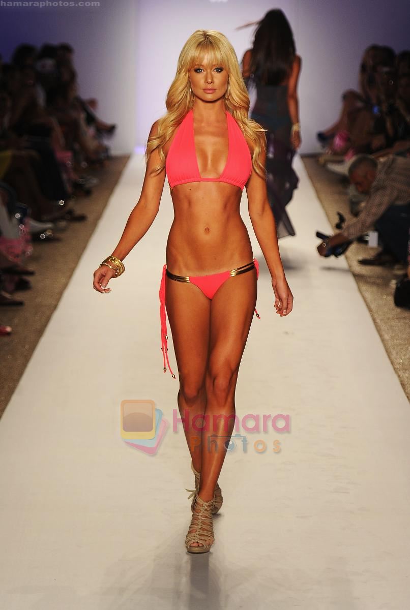 A model walks the runway during the Have Faith Swimwear show at The Raleigh on July 18, 2011 in Miami, Florida