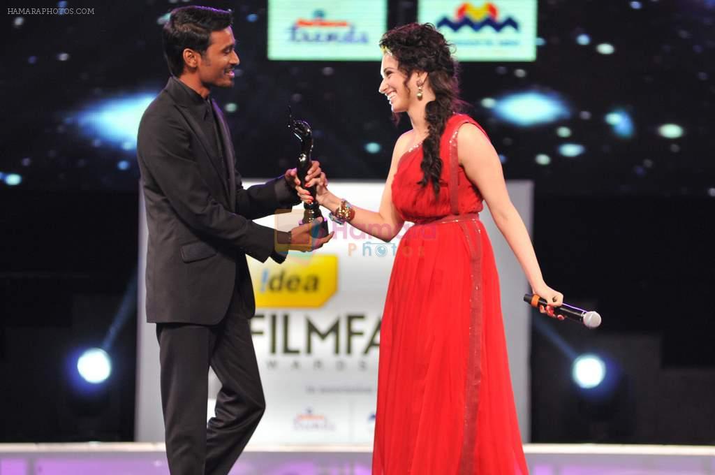 Dhanush receives the Best Actor - Male award for the movie 3 from Tamannaah during the 60th Filmfare Awards