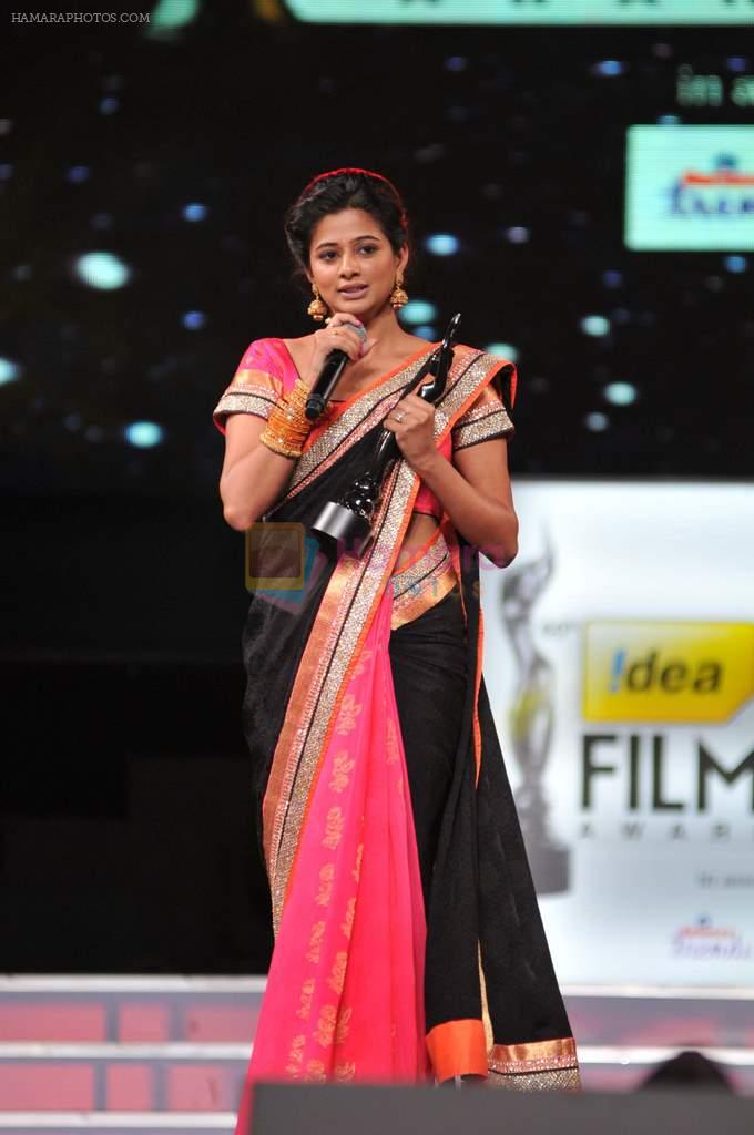 Priyamani receives the Best Actor - Female award for the movie Charulatha from Lakshmi Manchu and Jagapathy Babu during the 60th Filmfare Awards.