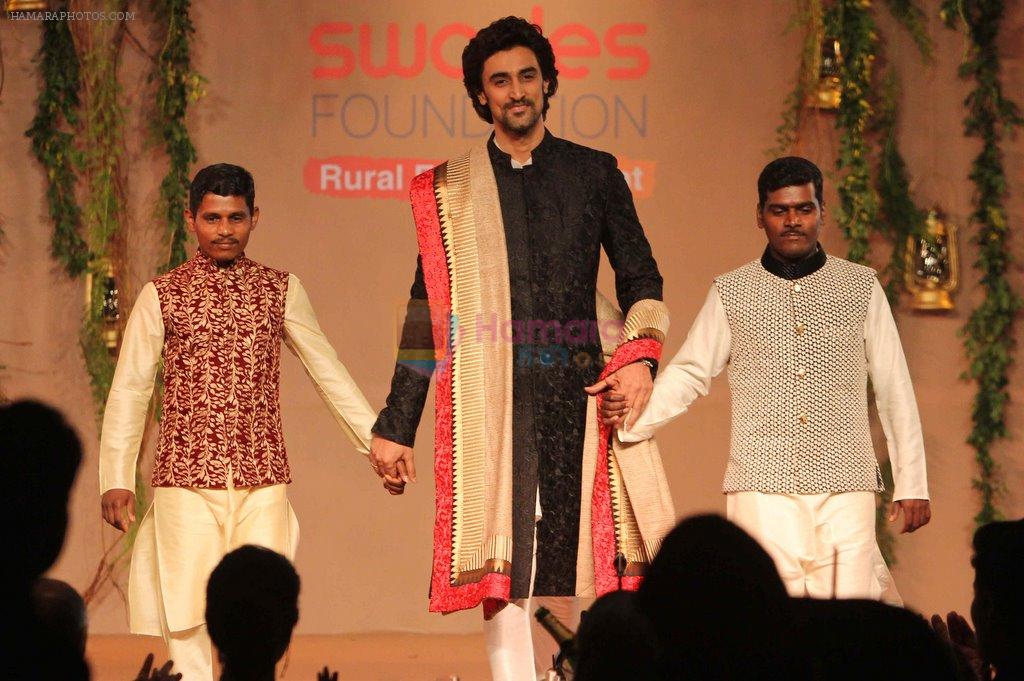 Kunal Kapoor walking the ramp with Raigadh villager at the Swades foundation's fundraiser event