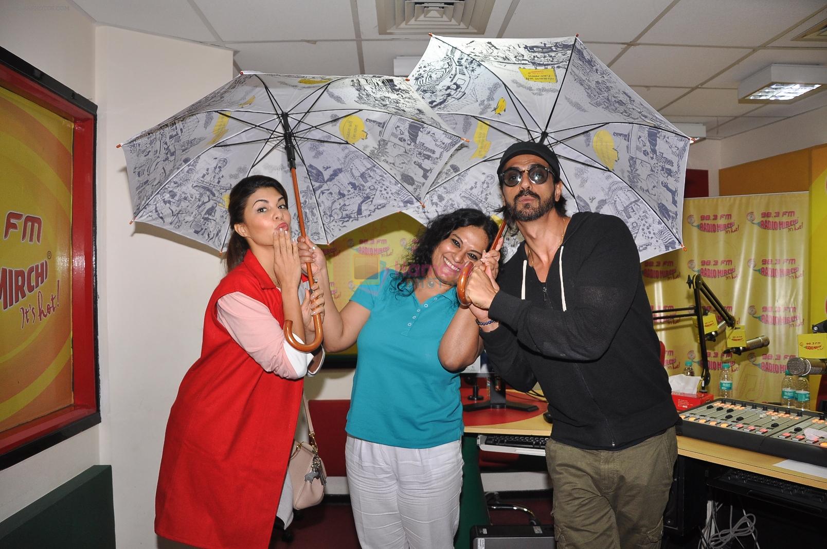 Jacqueline Fernandez & Arjun Rampal pose with RJ Prackriti at Radio Mirchi Mumbai studio for the promotion of Roy