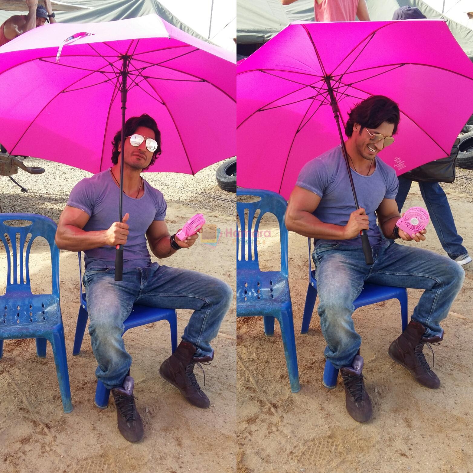 Vidyut Jammwal with a pink fan and umbrella on the sets of Commando 2 clicked by his Co star Adah sharma