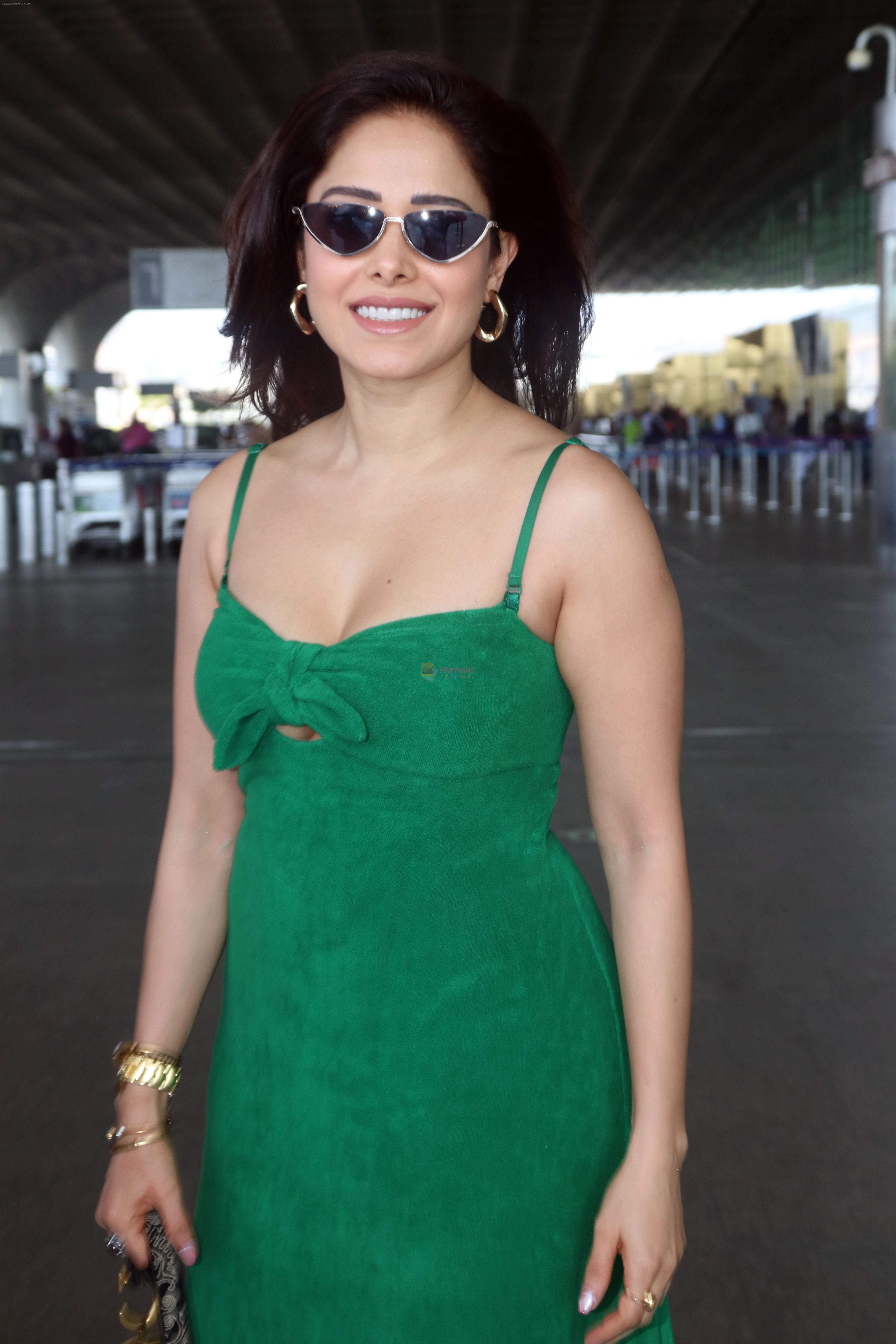 Nushrratt Bharuccha in shoulderless green dress with a tie knot wearing dark shades