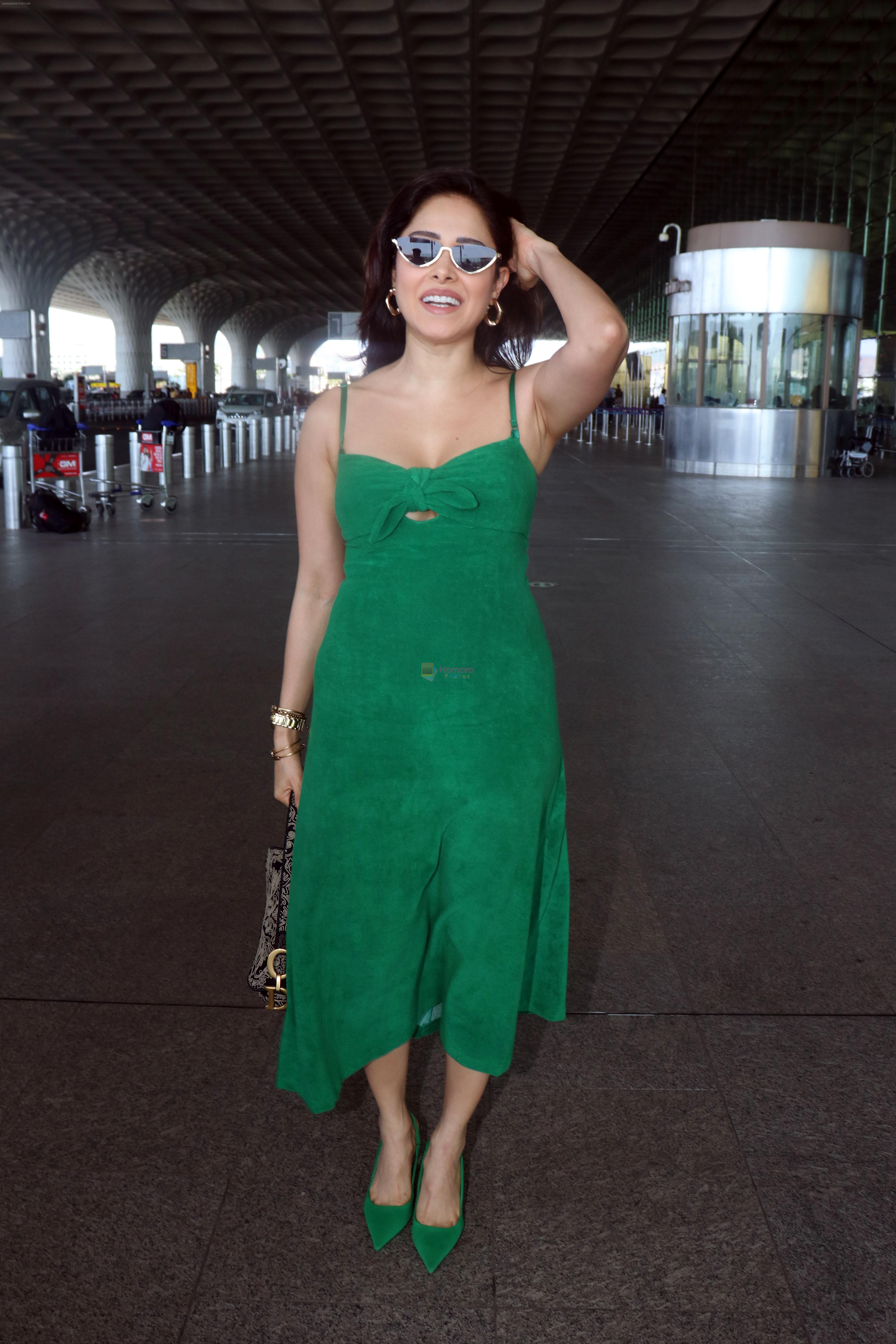 Nushrratt Bharuccha in shoulderless green dress with a tie knot wearing dark shades