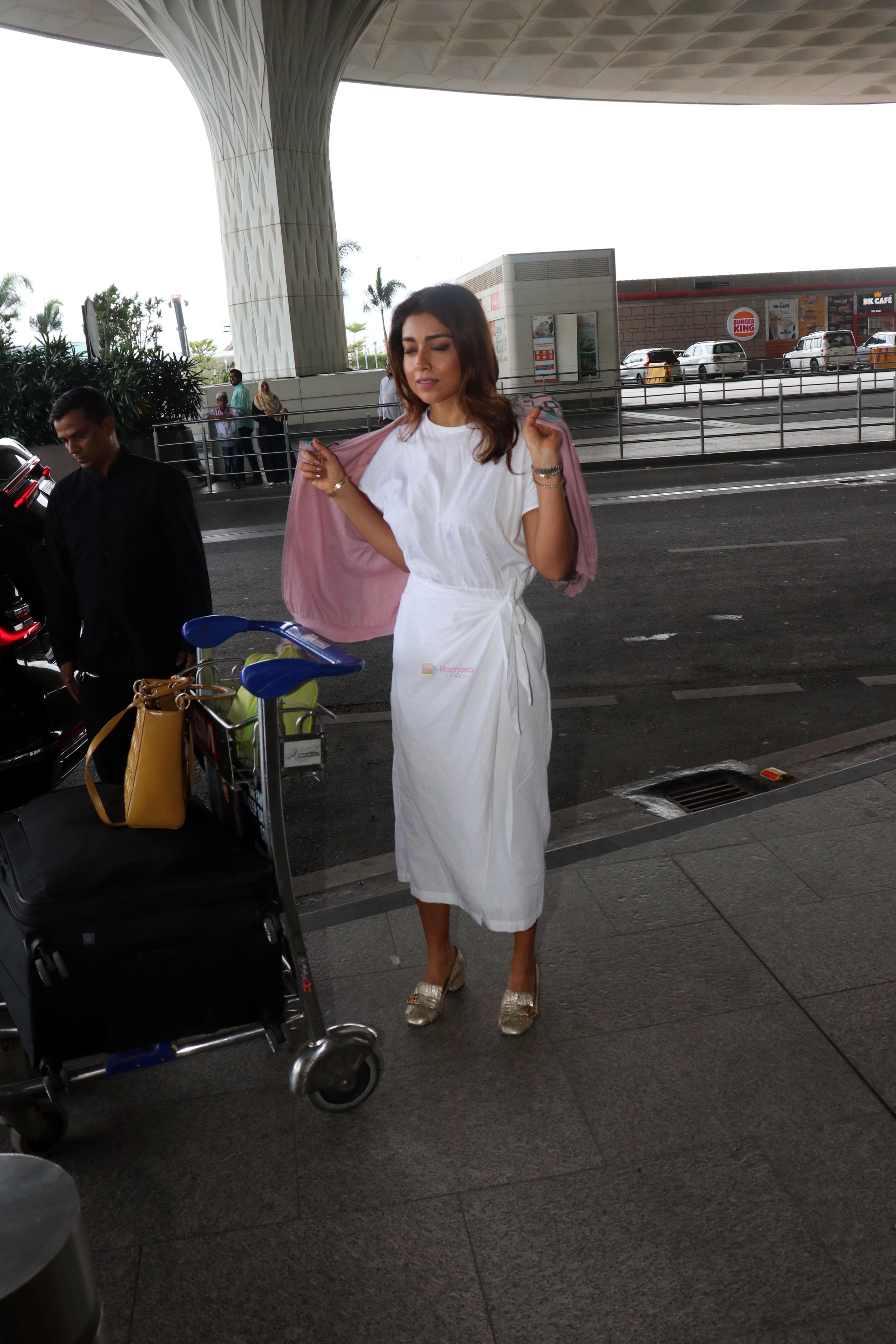 Shriya Saran in a white dress, pink coat design, holding Lady Dior Cannage two-way bag, Gucci Metallic Gold Textured Leather GG Marmont Fringe Detail Heel Pumps