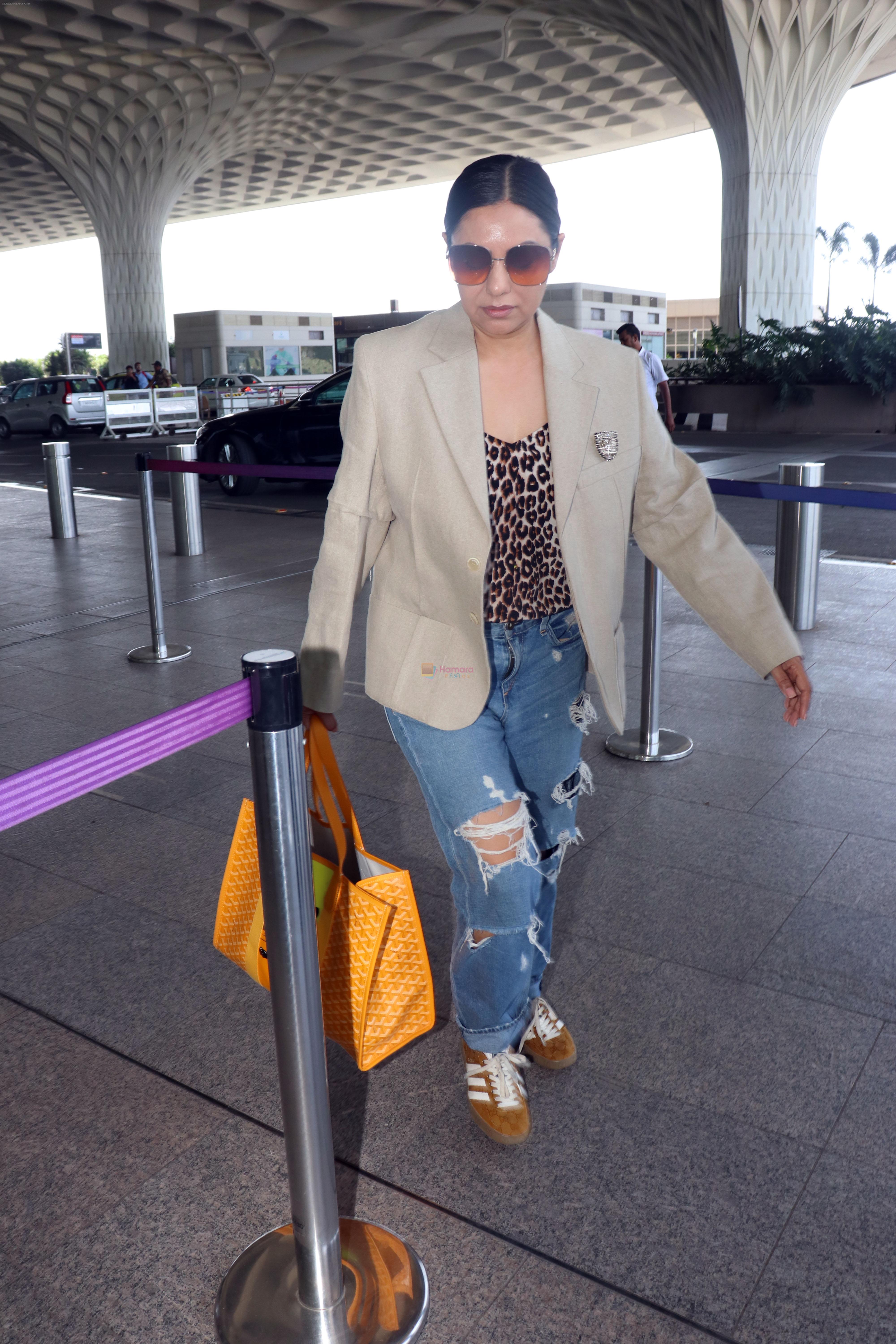 Gauahar Khan holding Villette Tote Bag wearing Gazelle Gucci Mesa White Red shoes, Balmain distressed effect finish jeans, overcoat and sunglasses