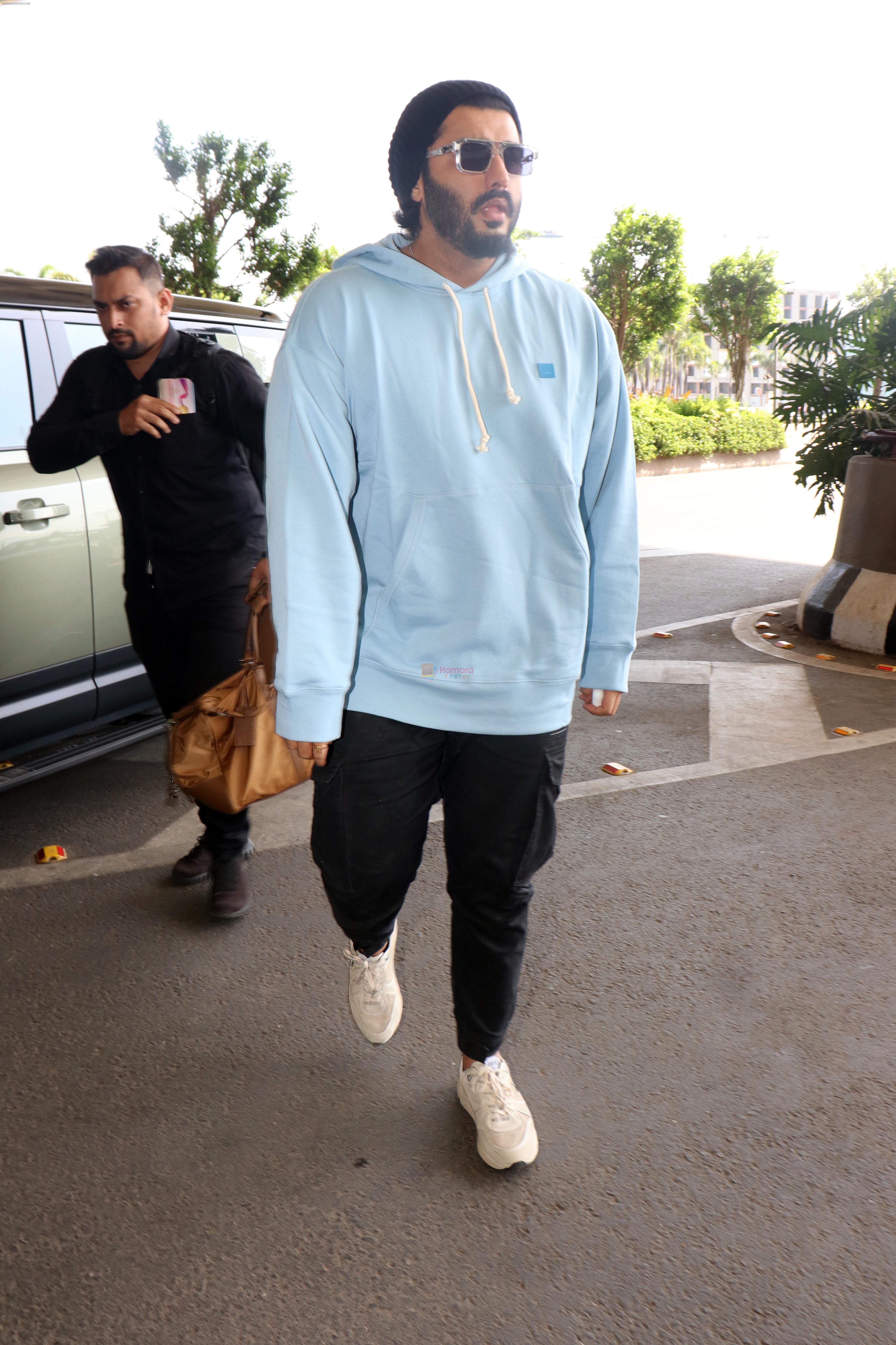 Arjun Kapoor with sunglasses on wearing Powder Blue Hooded Sweatshirt and black sweatpant, white sneakars and beanie cap