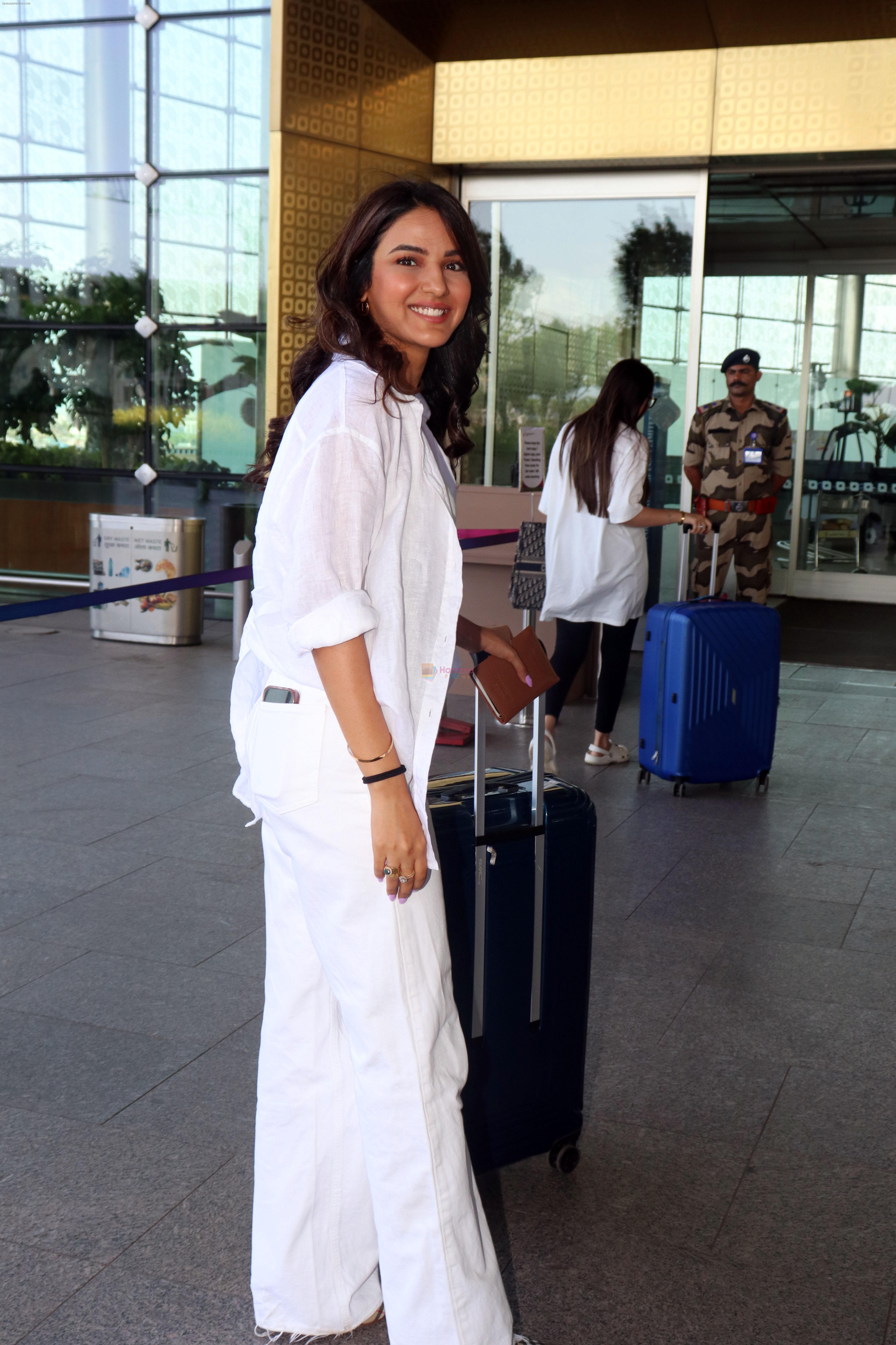 Jasmin Bhasin dressed in white holding Burberry Tote handbag