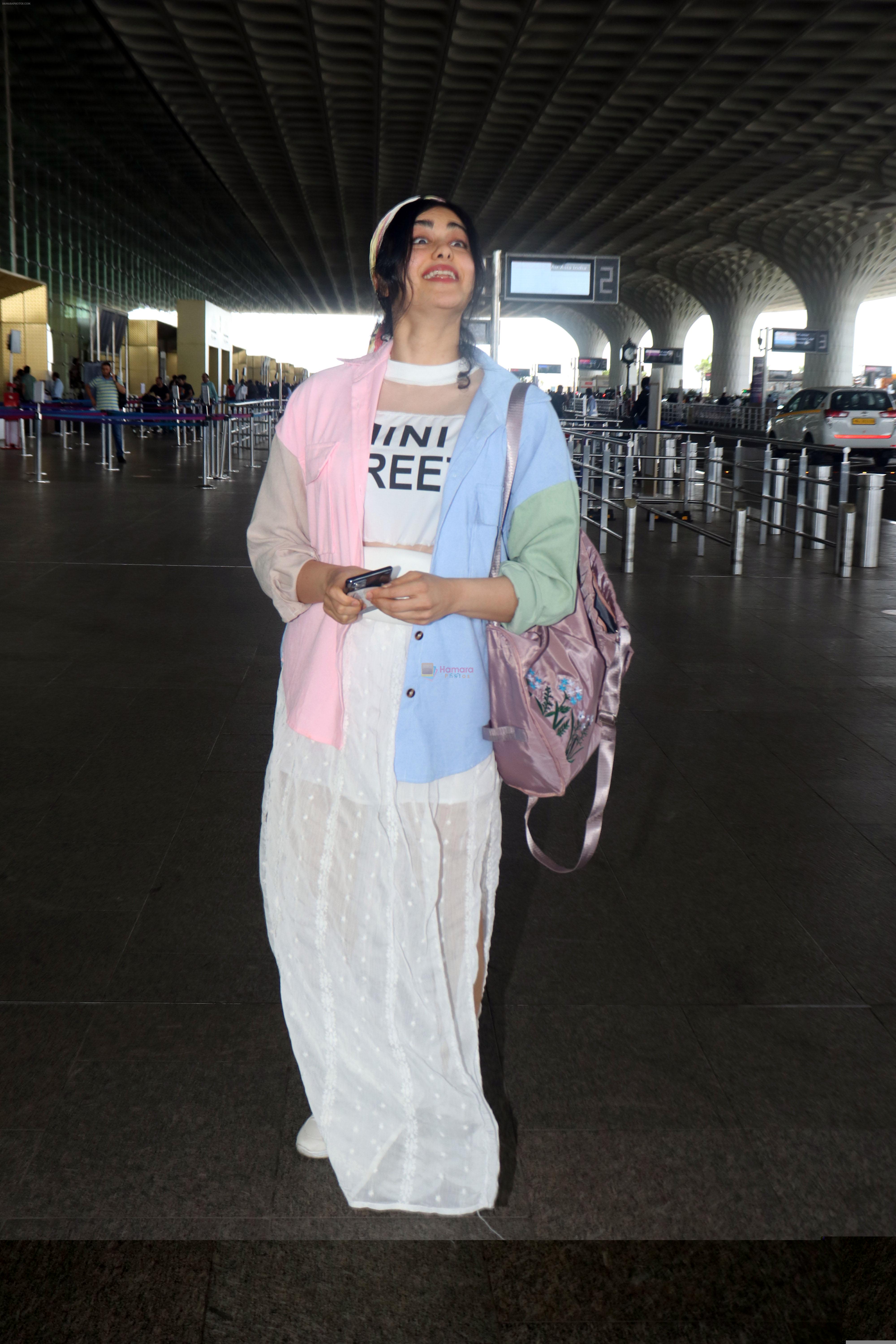 Adah Sharma holding travel folding bag dressed in an urbanic patchwork placket bouse and transparent skirt