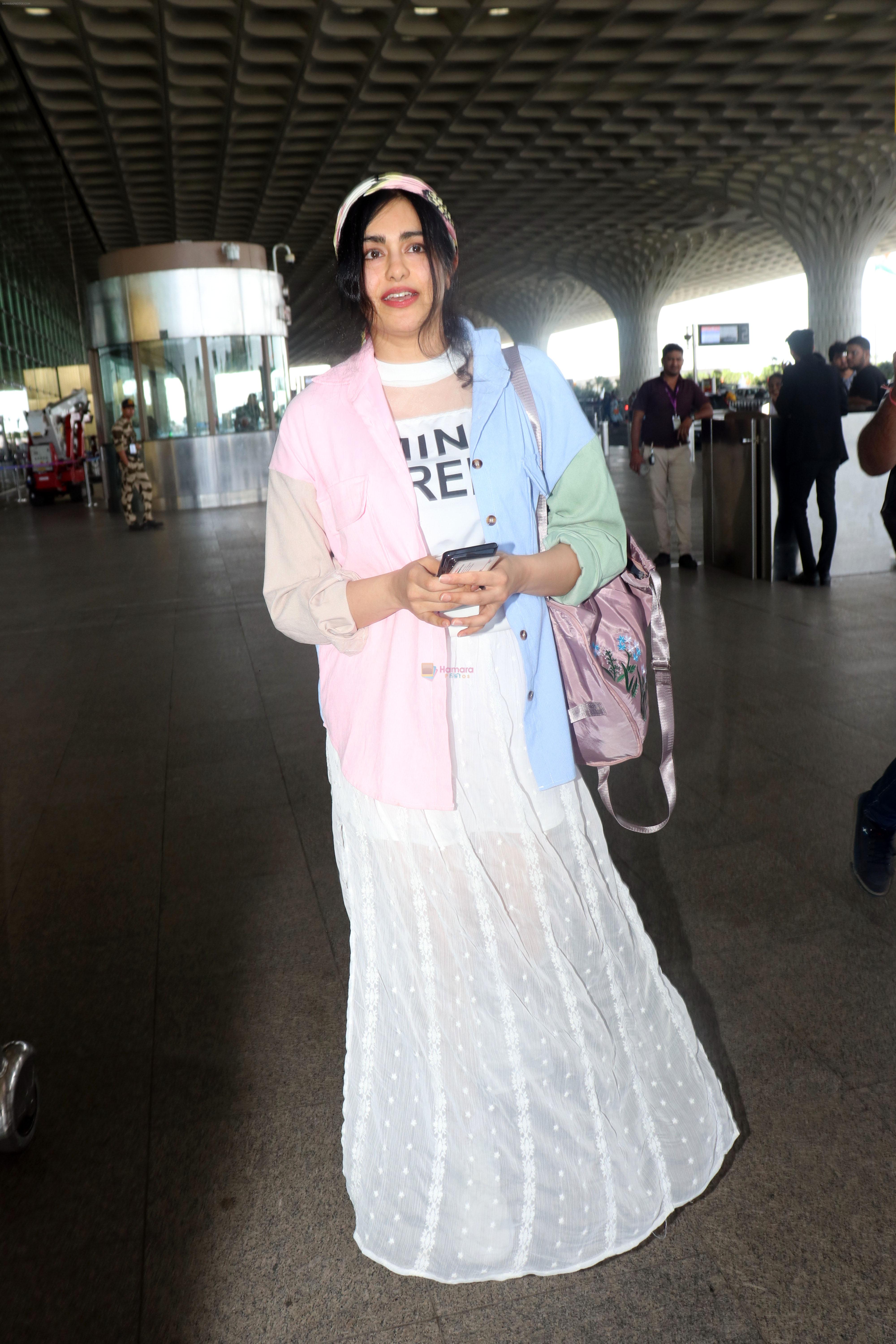 Adah Sharma holding travel folding bag dressed in an urbanic patchwork placket bouse and transparent skirt