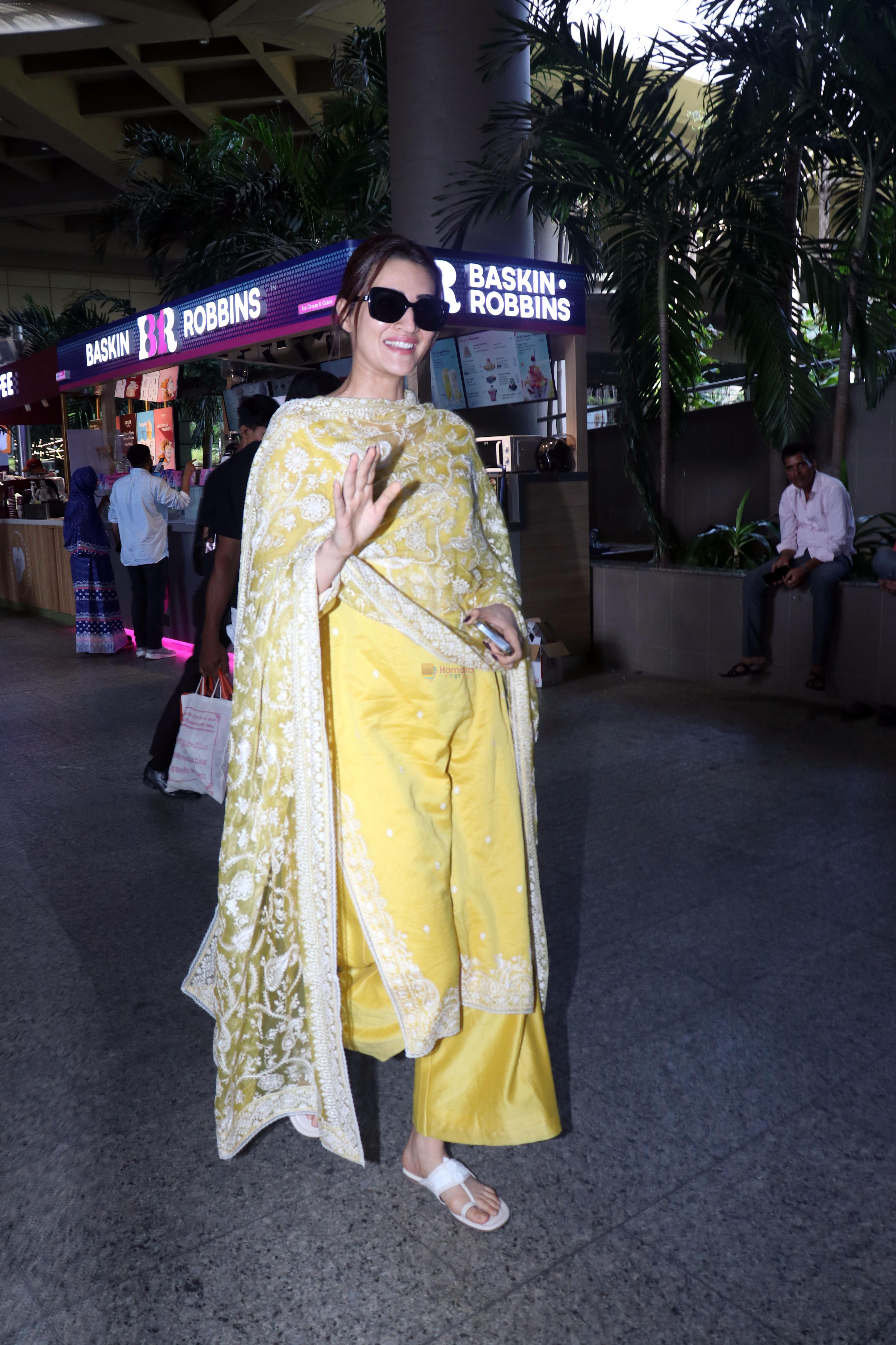 Kriti Sanon dressed in yellow churidar wearing black sunglasses