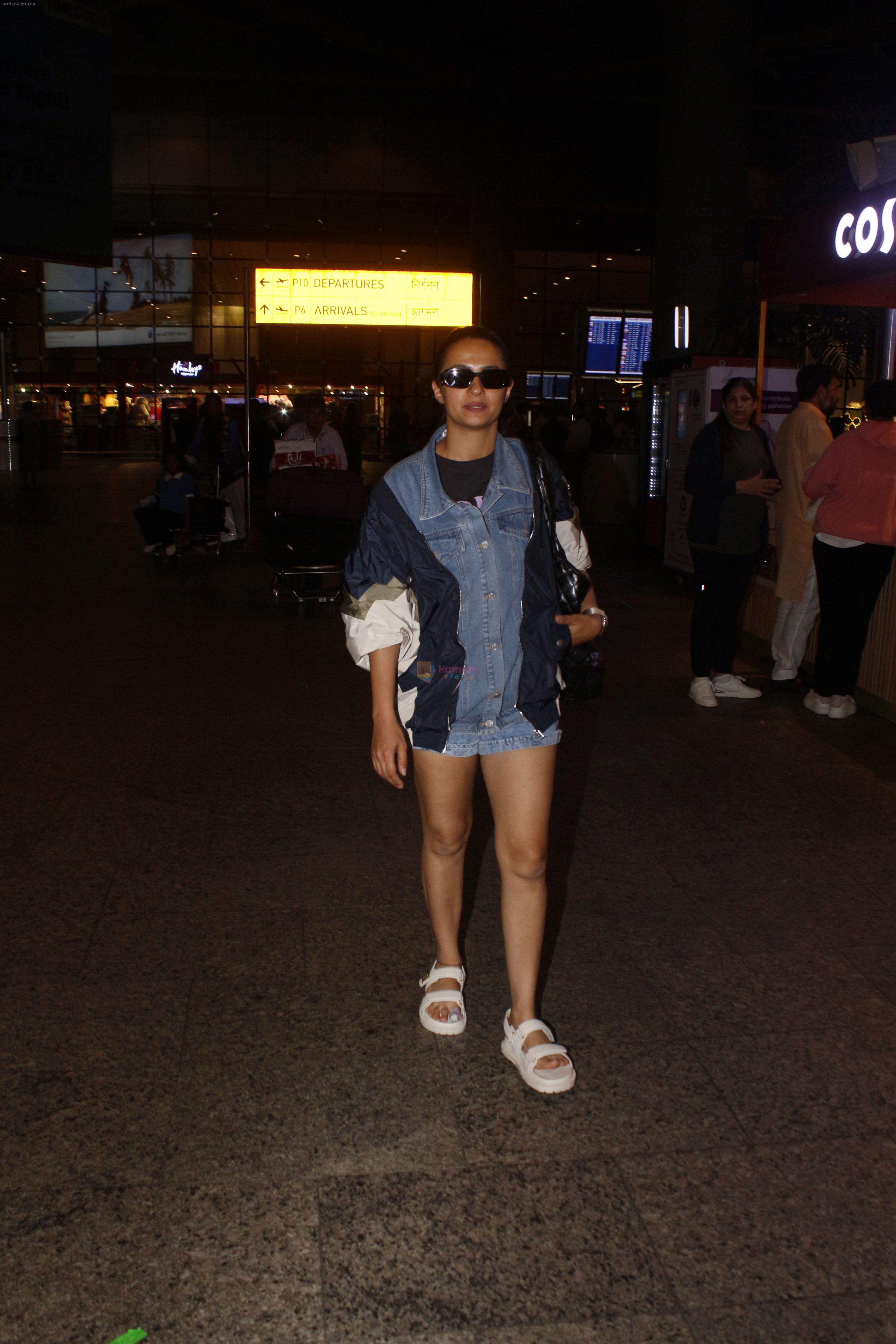 Surveen Chawla dressed in short jeans and blue jackets seen at the airport on 1 July 2023