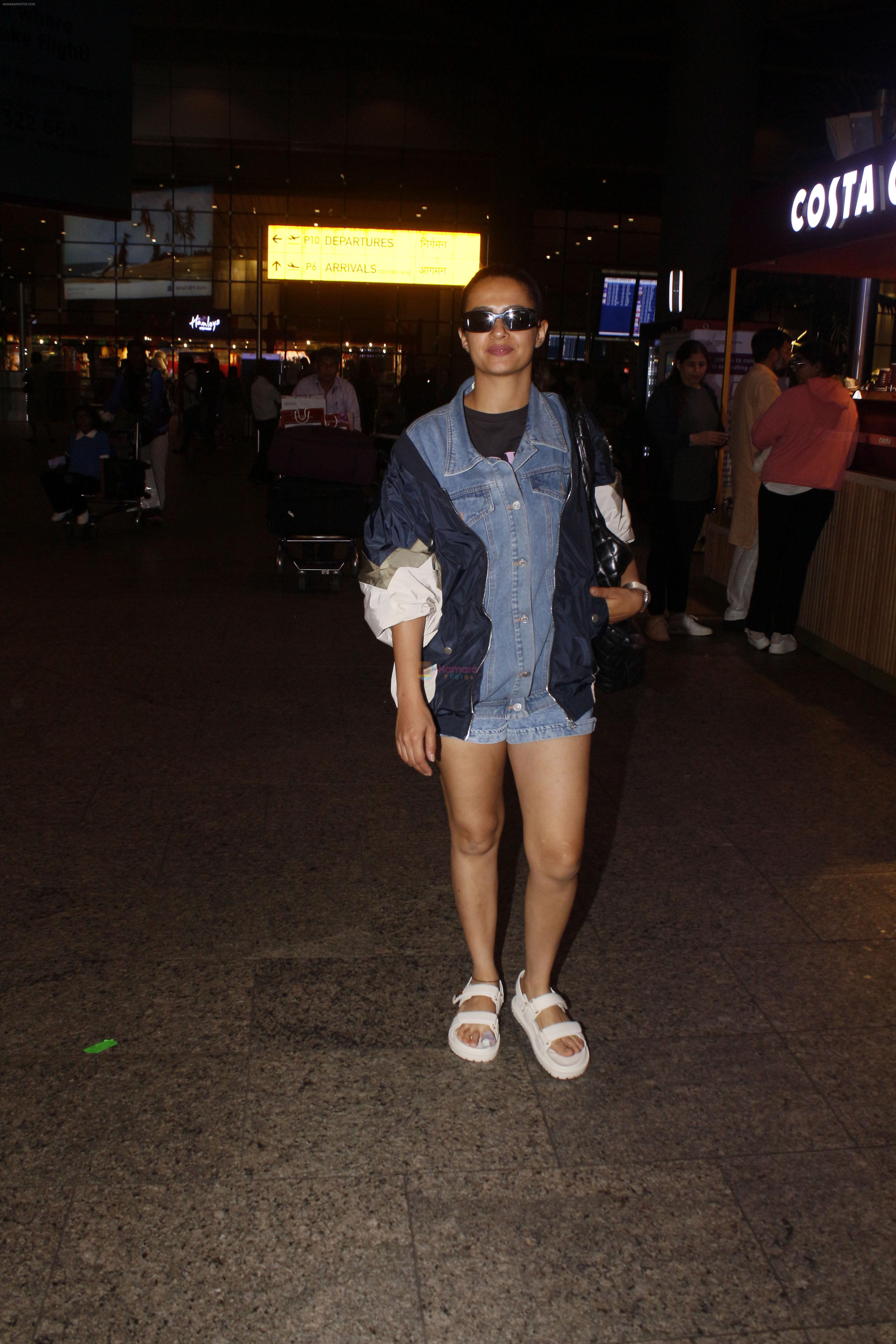 Surveen Chawla dressed in short jeans and blue jackets seen at the airport on 1 July 2023