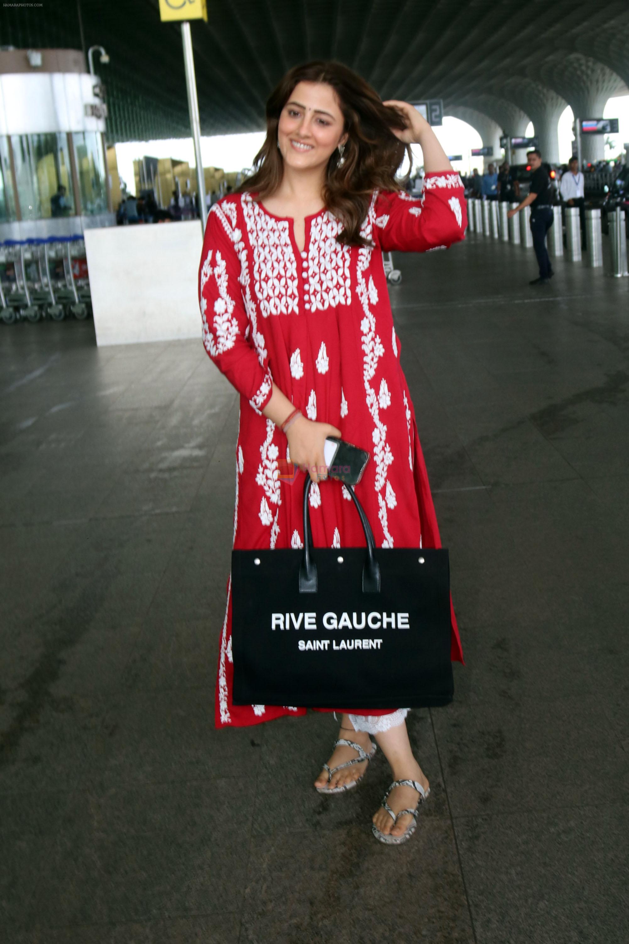 Nupur Sanon seen shinnig in red at the airport holding Saint Laurent handbag on 9 July 2023