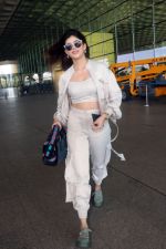 Sanjana Sanghi holding bag wearing cream colored long sleeved top and trousers and grey footwear with laces (12)_646f3ee789ea6.jpg
