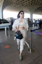 Sanjana Sanghi holding bag wearing cream colored long sleeved top and trousers and grey footwear with laces (15)_646f3ef1eff9b.jpg