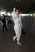 Sanjana Sanghi holding bag wearing cream colored long sleeved top and trousers and grey footwear with laces (20)_646f3f02a43c2.jpg