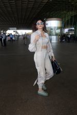 Sanjana Sanghi holding bag wearing cream colored long sleeved top and trousers and grey footwear with laces (21)_646f3f05ee64a.jpg