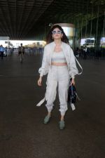 Sanjana Sanghi holding bag wearing cream colored long sleeved top and trousers and grey footwear with laces (22)_646f3f08d1d42.jpg