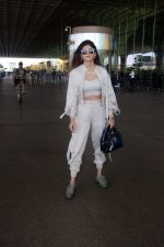 Sanjana Sanghi holding bag wearing cream colored long sleeved top and trousers and grey footwear with laces (24)_646f3f0f1af2b.jpg
