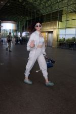 Sanjana Sanghi holding bag wearing cream colored long sleeved top and trousers and grey footwear with laces (4)_646f3ecfb2b06.jpg