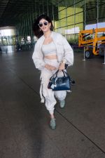 Sanjana Sanghi holding bag wearing cream colored long sleeved top and trousers and grey footwear with laces (7)_646f3ed8933ed.jpg