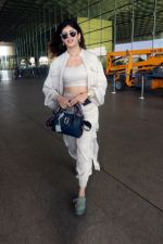 Sanjana Sanghi holding bag wearing cream colored long sleeved top and trousers and grey footwear with laces (9)_646f3ede80408.jpg