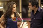 Neha Dhupia and Paresh Rawal in the still from movie Maharathi.jpg
