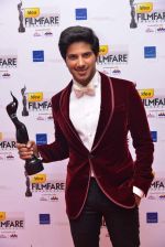 Dulquer Salmaan with his award for Best Debut (Male) at the 60th Idea Filmfare Awards South.jpg